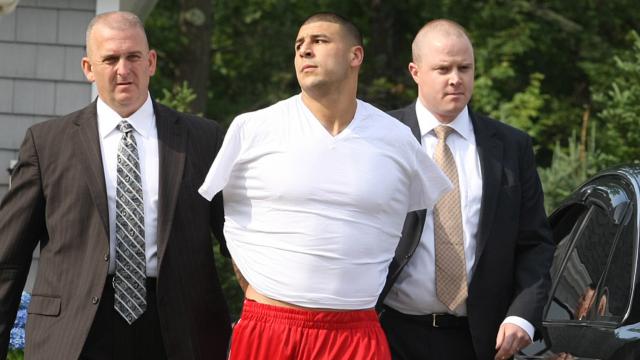 Aaron Hernandez being taken into custody by police in June 2013