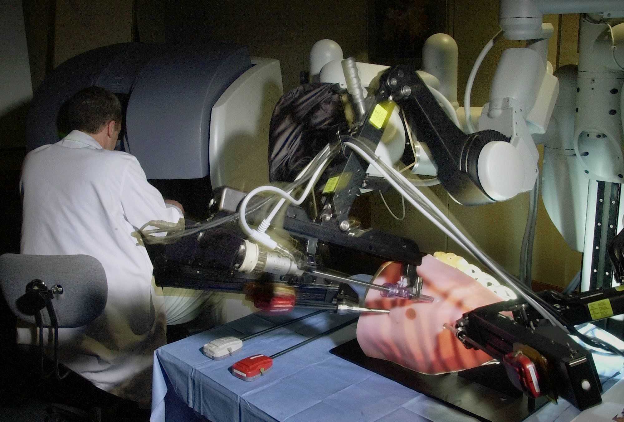 Dr. Yvon Baribeau manipulated the controls of a surgical robot working inside an artificial chest cavity at Catholic Medical Center in 2002. 