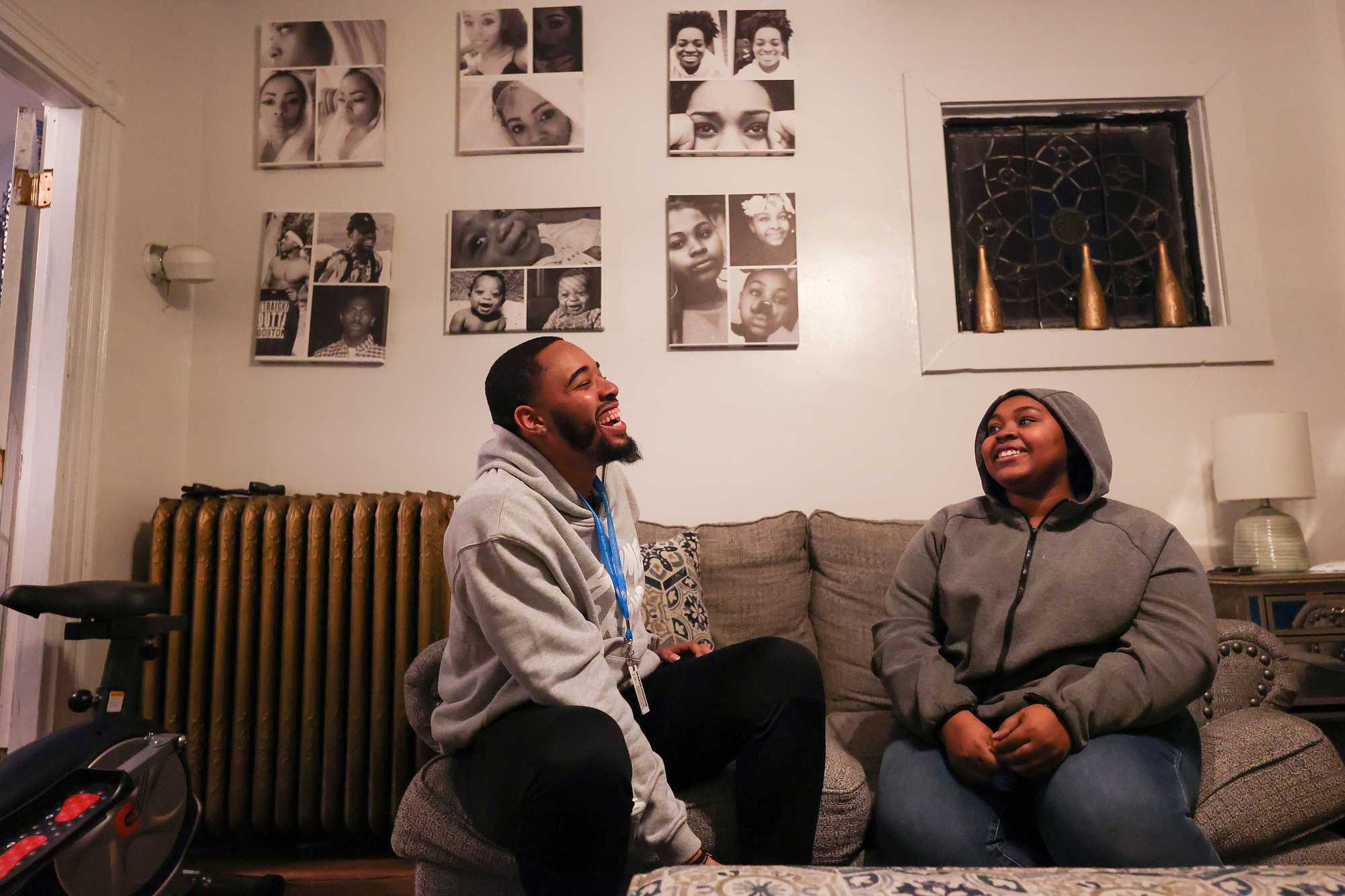 Hassan Paige (left) tries to put a few hundred dollars into savings each month. Here, he shared a laugh with Chyan Johnson, 18, one of the cousins and roommates.