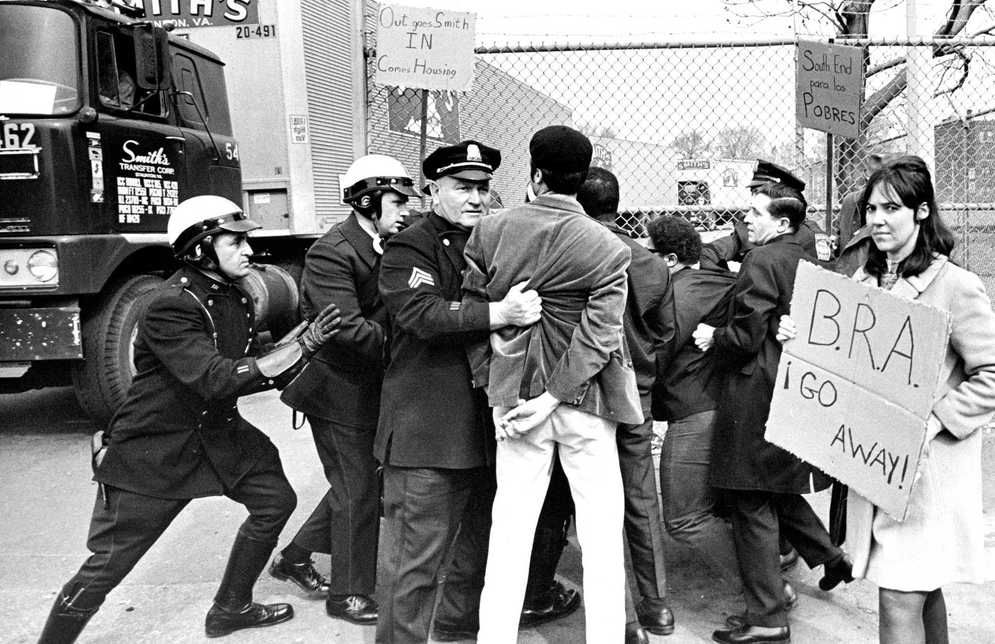 Boston, MA - 4/30/1968: Boston Police force protesters aside so that trucks can move at the Smith Transfer Corp. truck terminal on Tremont Street in the Roxbury neighborhood of Boston on April 30, 1968. Anti-urban renewal demonstrators from the Community Assembly for a Unified South End (CAUSE) were picketing the terminal, demanding that Lenox Street apartments be renovated rather than demolished and that the Smith Transfer property be used as a site for low-rent housing.  (Ollie Noonan Jr./Globe Staff) --- BGPA Reference: 171206_BS_018