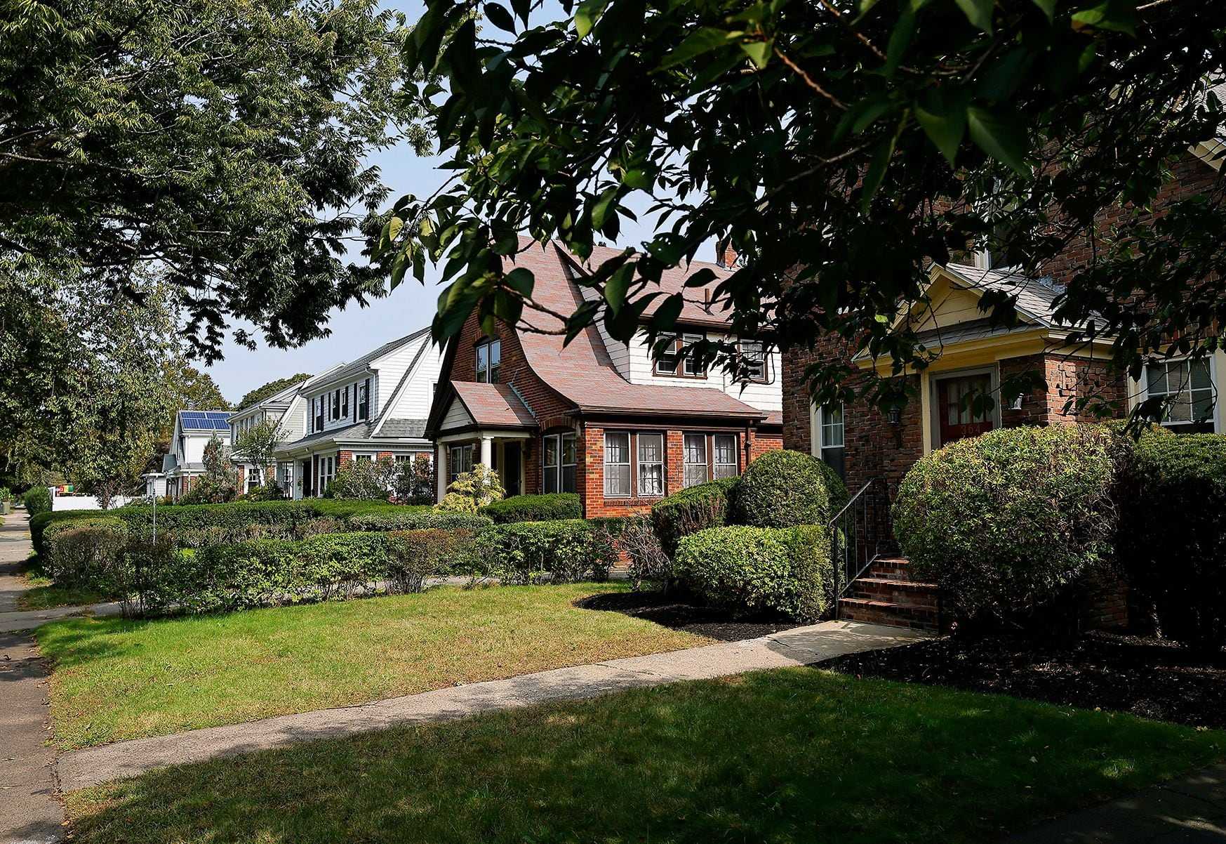 Homes with well-kept yards line Blue Hills Parkway in Milton.