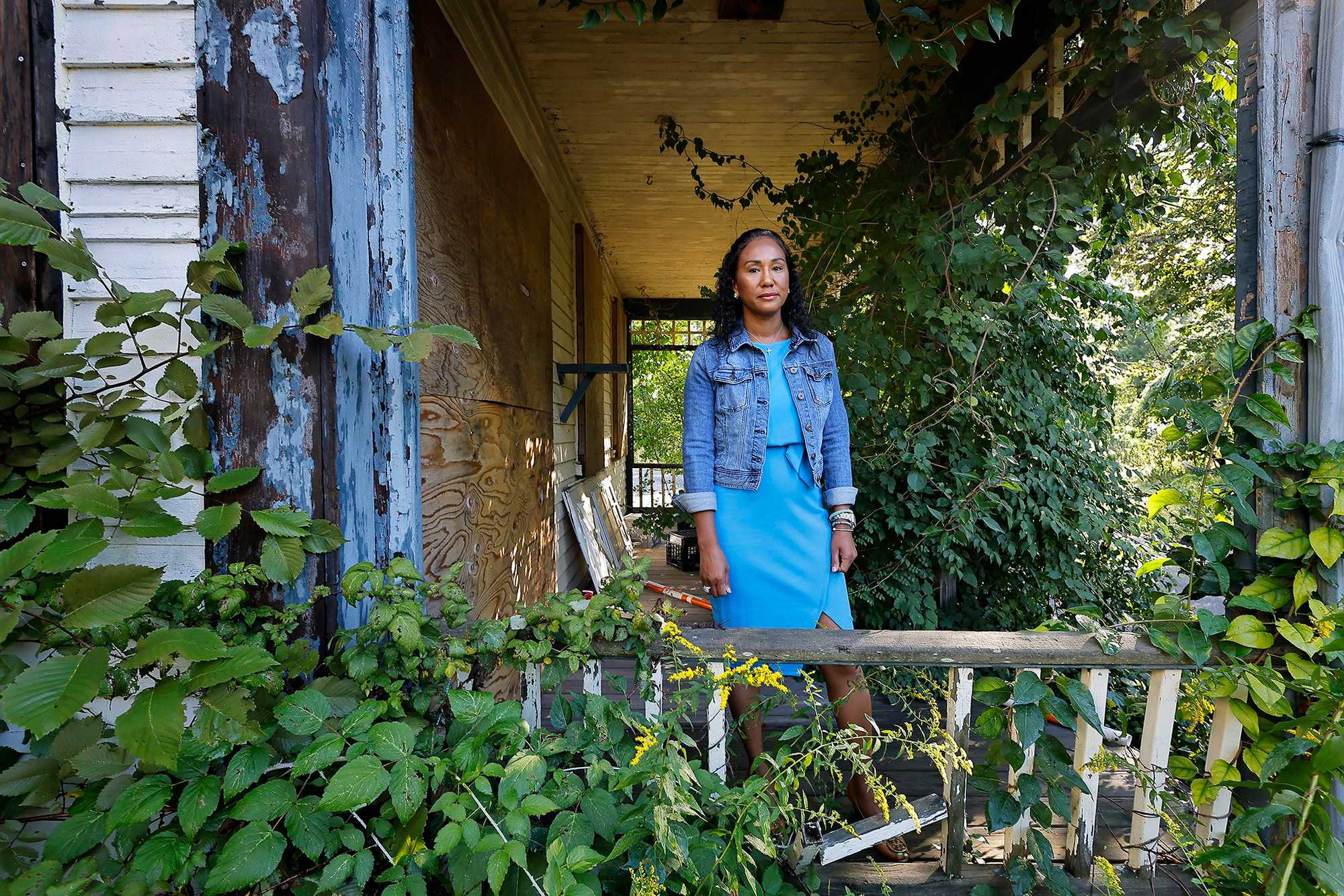 Linda Champion benefitted from subsidized housing to attend college and law school, and  believes affordable housing is a critical piece of social mobility. Champion stands among the remaining buildings of Milton’s former Town Farm, where some town officials hope to bring an affordable housing development. 
