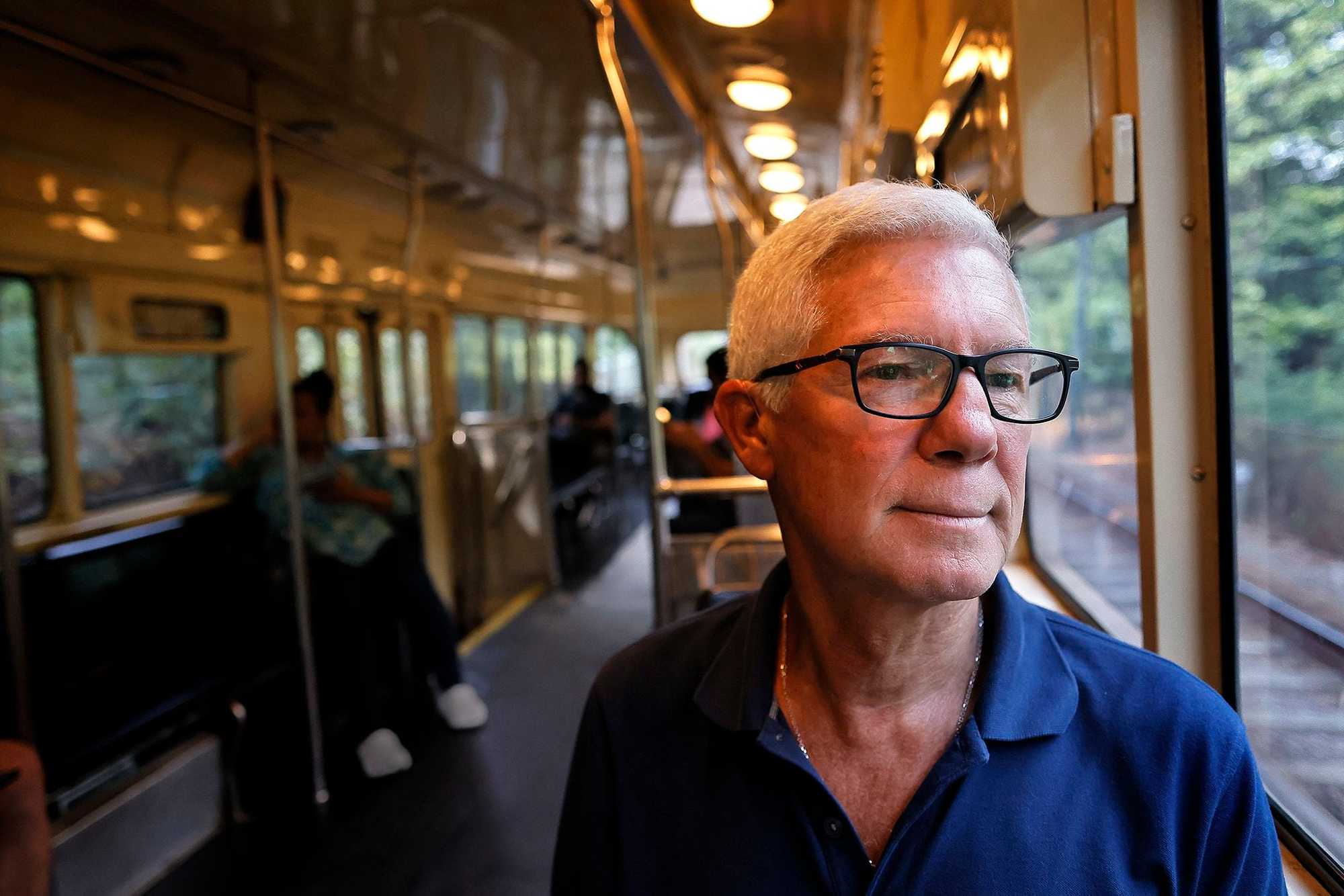 Brian O'Halloran, of Milton, is concerned about the ramifications of a state law requiring new zoning in towns served by the MBTA. He is pictured riding the Mattapan Trolley, the rail service that brings Milton under the law's mandates.