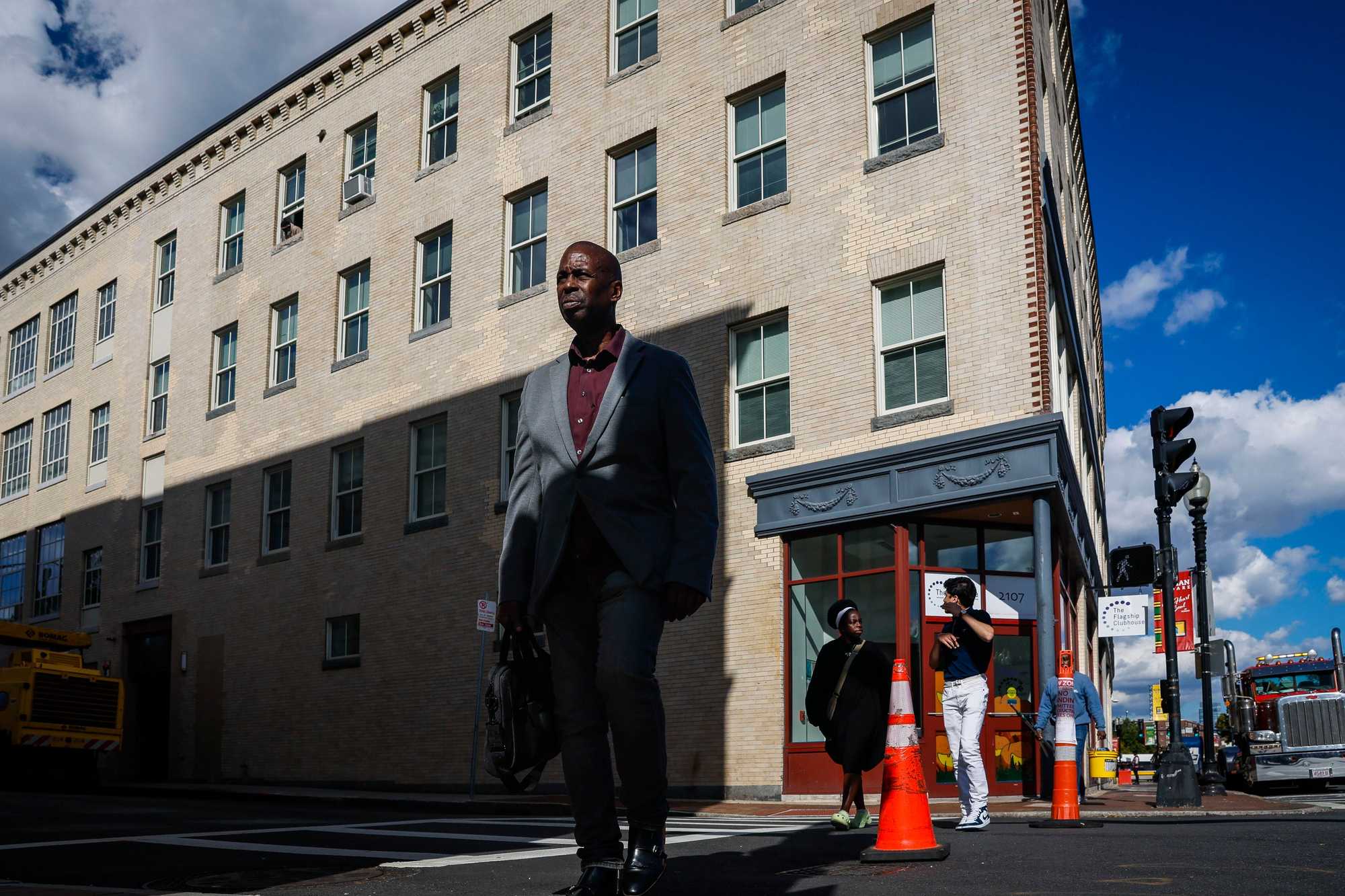 Pedestrians crossed near the former Tropical Foods grocery store in Nubian Square. The nonprofit Madison Park Development Corp. rehabbed the building for housing using funds from the One Dalton deal and included 21 affordable apartments.