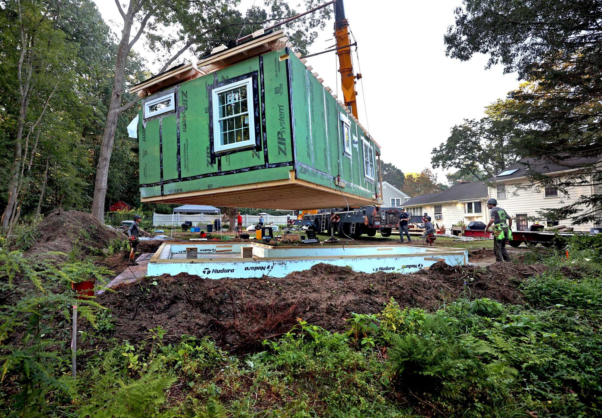 CONCORD, MA - 8/23/2023:  XXSINGLEFAMILY.HOUSING. ....... A constructed Accessory Dwelling Unit lowered by crane into a backyard in Concord. ADUs are only allowed by special permit in some Massachusetts towns, requiring developers to sit through vitriolic public hearings that can add months and costs to a project. Massachusetts legislators have declined to pass any legislation permitting the units statewide.  Meanwhile, California is set to soon hit 100,000 new ADUs built since 2018 after relaxing its laws to broadly allow the structures. (David L Ryan/Globe Staff ) SECTION:  SPOTLIGHT