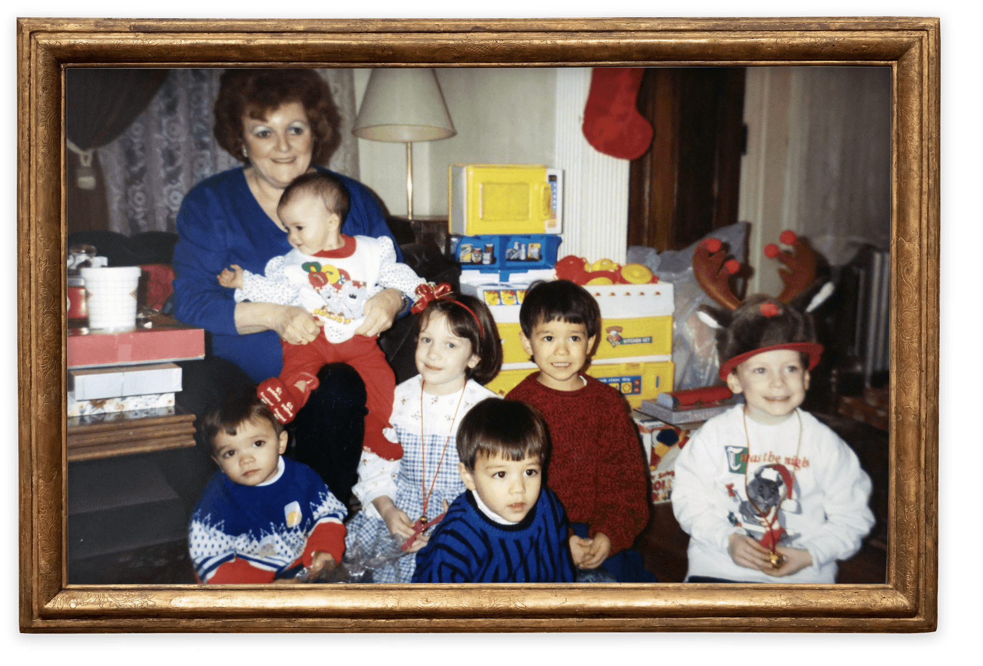  Mary Logue holds her granddaughter, Amanda, as she sits with her grandchildren — James, Catherine, Justin, Brendan, and Michael (left to right) — in 1992. 

