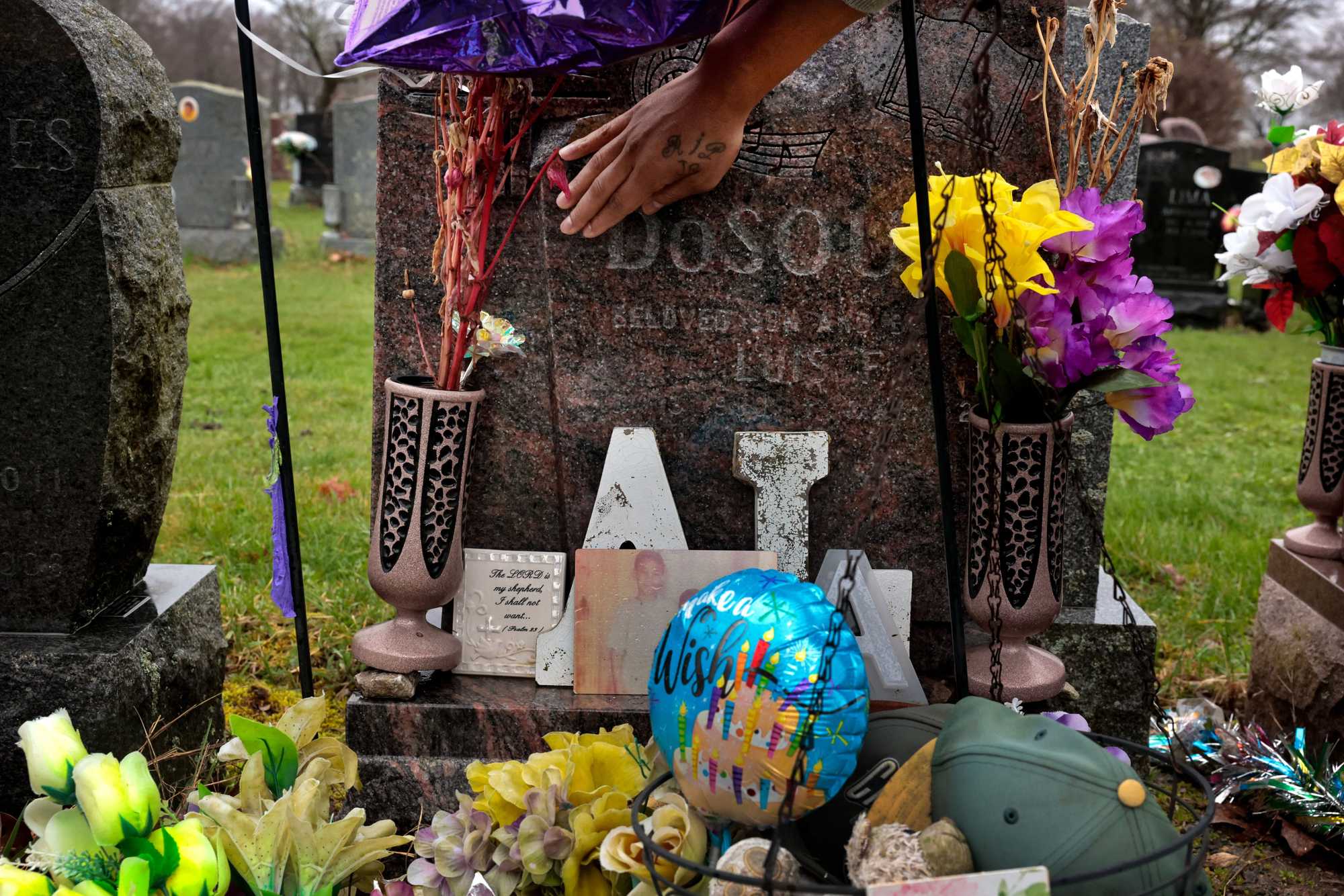 Steve "Nugget" DoSouto visited the grave at New Calvary Cemetery shared by his slain brothers, Luis and Alex. 