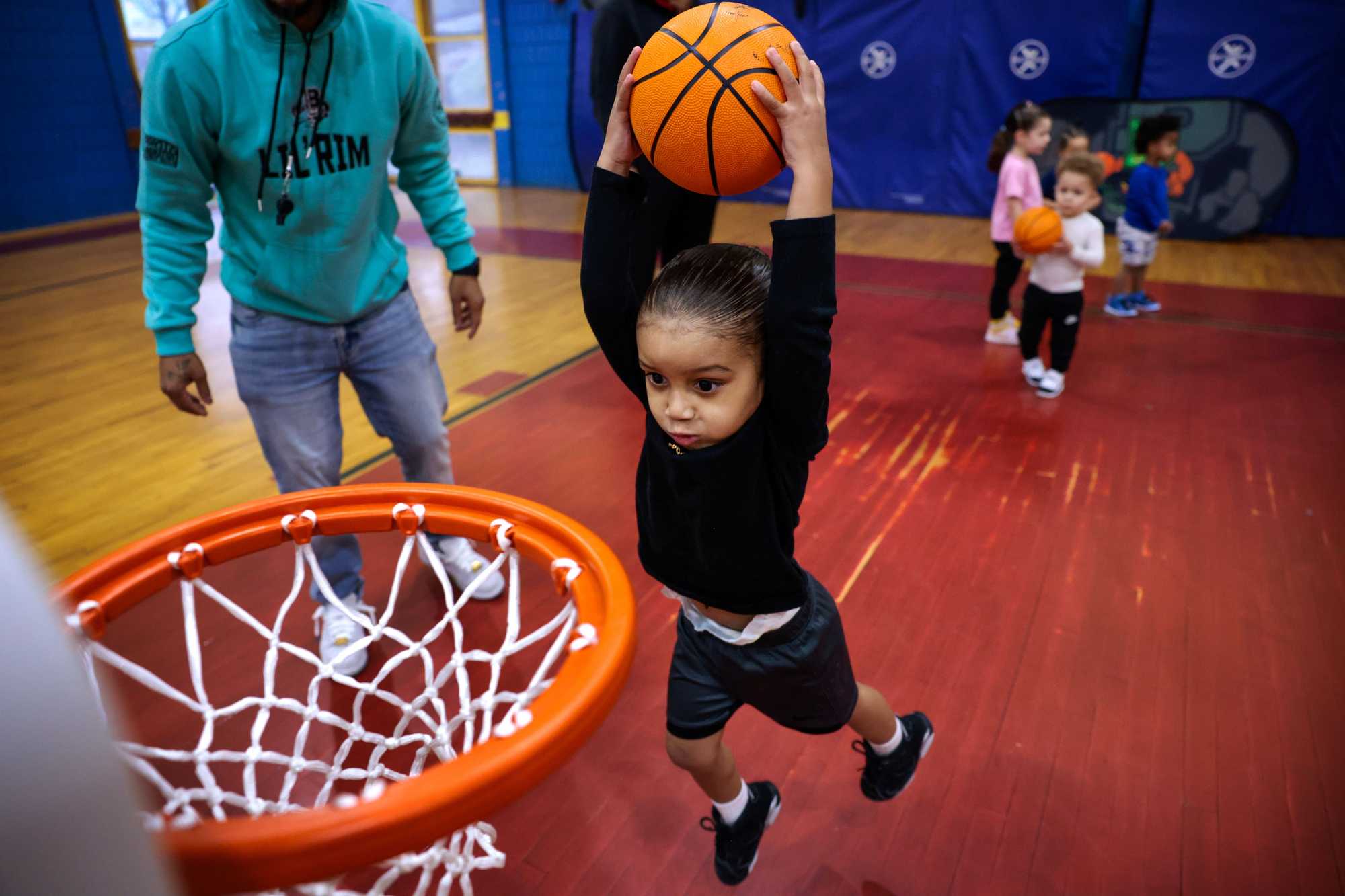 Milton DoSouto's son, Alex, named for Milton's slain brother, went up for a practice dunk in his uncle Nugget's program for preschoolers at the Holland Community Center.