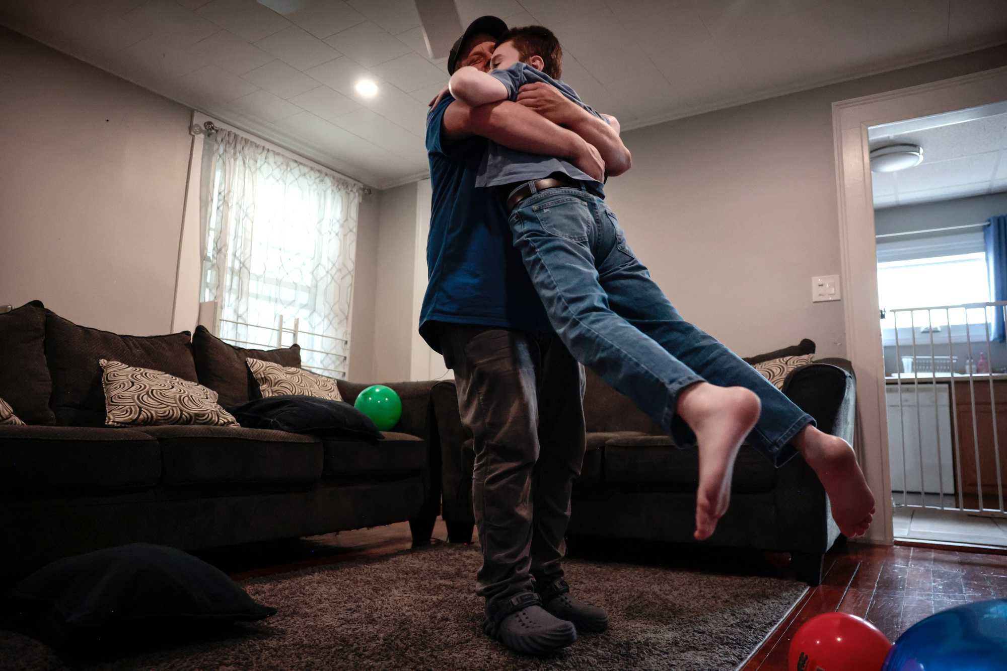 Phil Corriveau welcomed Dante home from school with a big hug and a spin at their home in Wakefield in April. Dante was arriving home from the Amego School, which specializes in teaching students with autism.