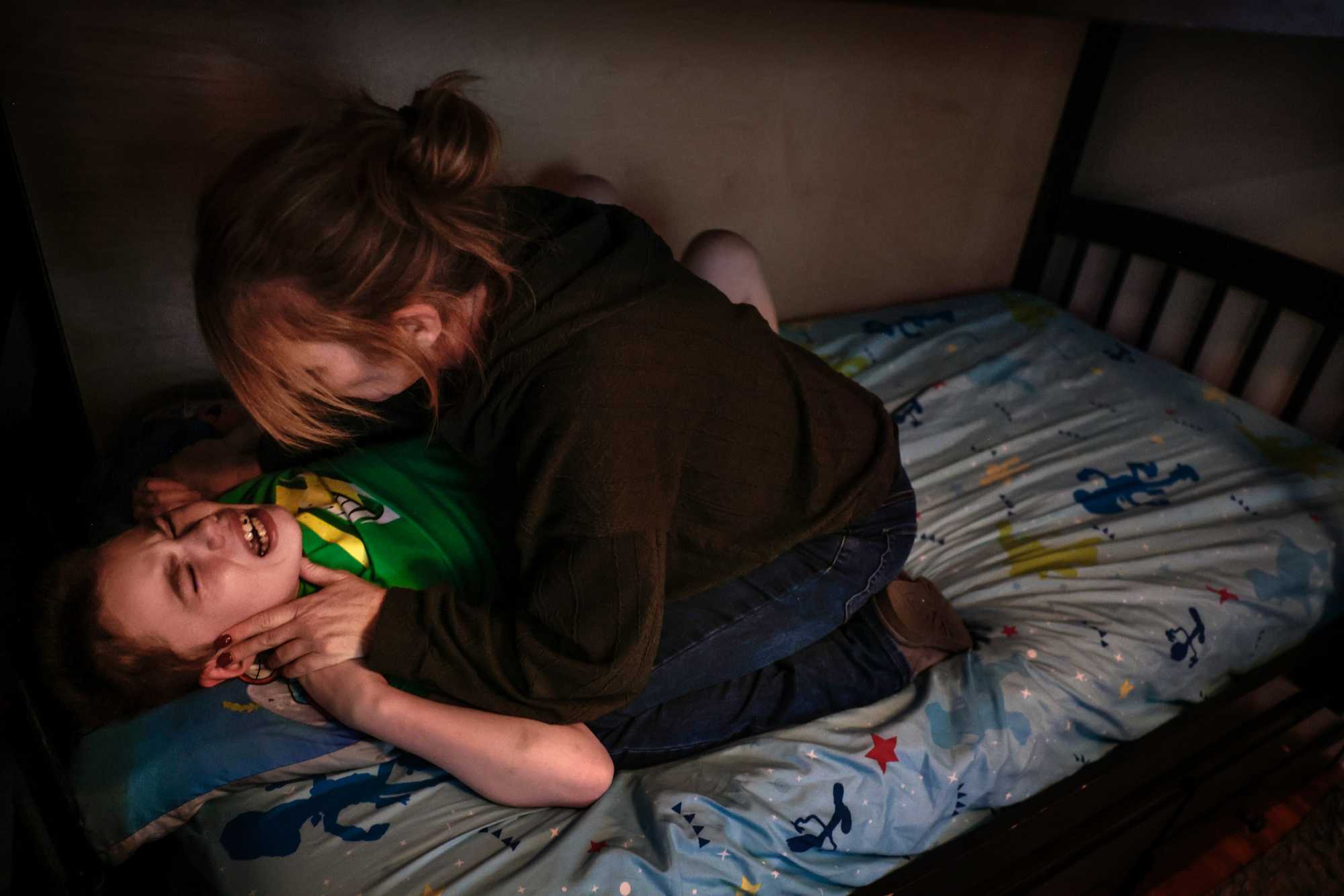 Jen Fowler restrained Dante during an episode at their home in Wakefield in February, his 16th month without school. Jen refers to 2 p.m. as the “bewitching hour” when Dante’s episodes begin.
