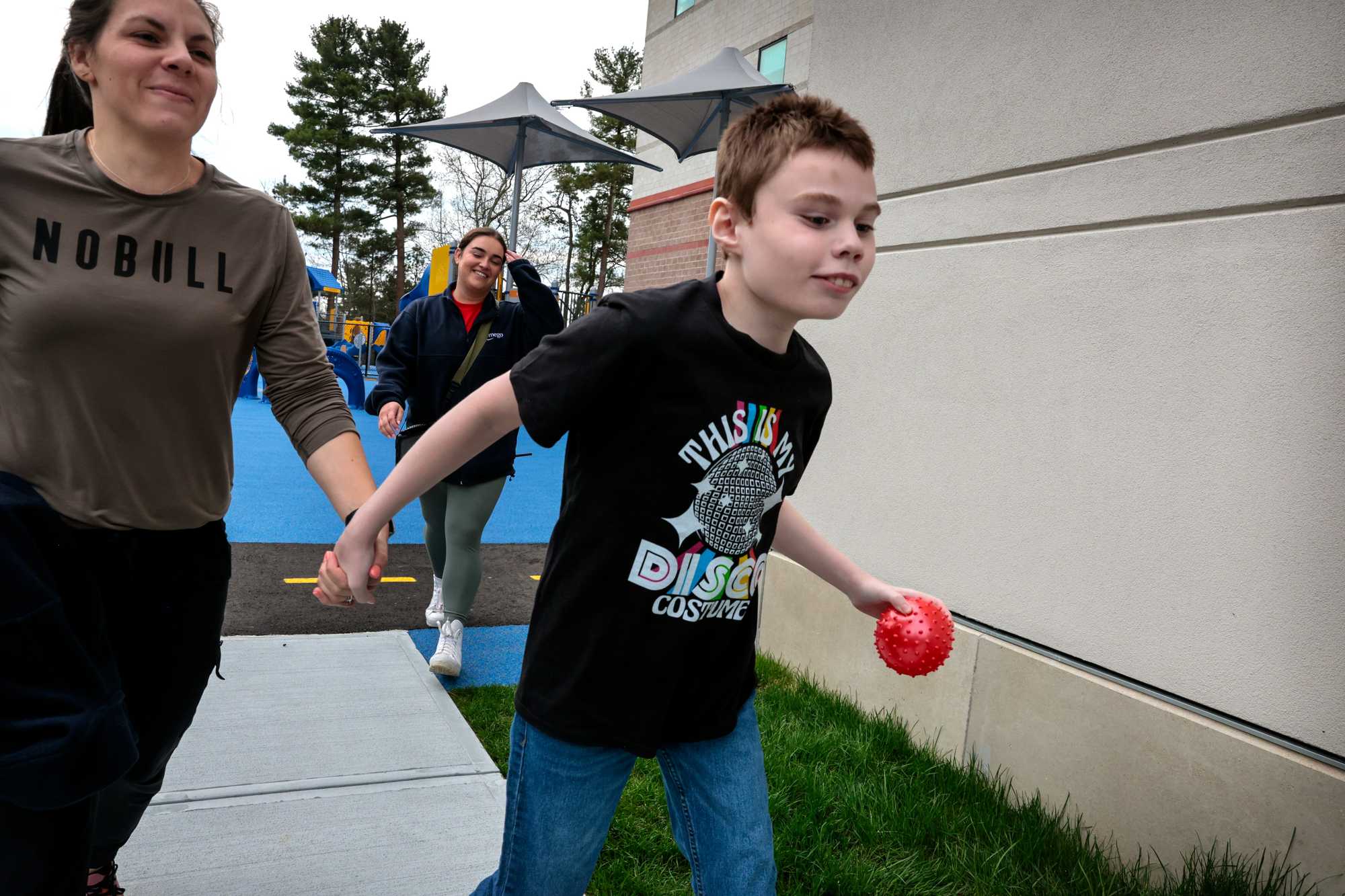 Dante Fowler ran back to class with speech pathologist Marley Dutcher after a break on the playground at the Amego School in Franklin in April. After completing a series of lessons Dante is rewarded with a recreational period.