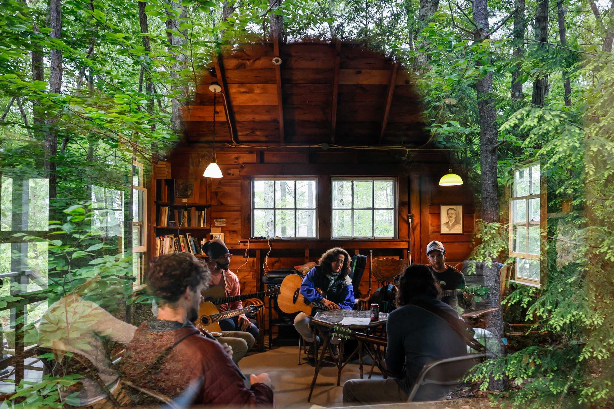 Jane Minasian (center) photographed through a window during a guitar class.