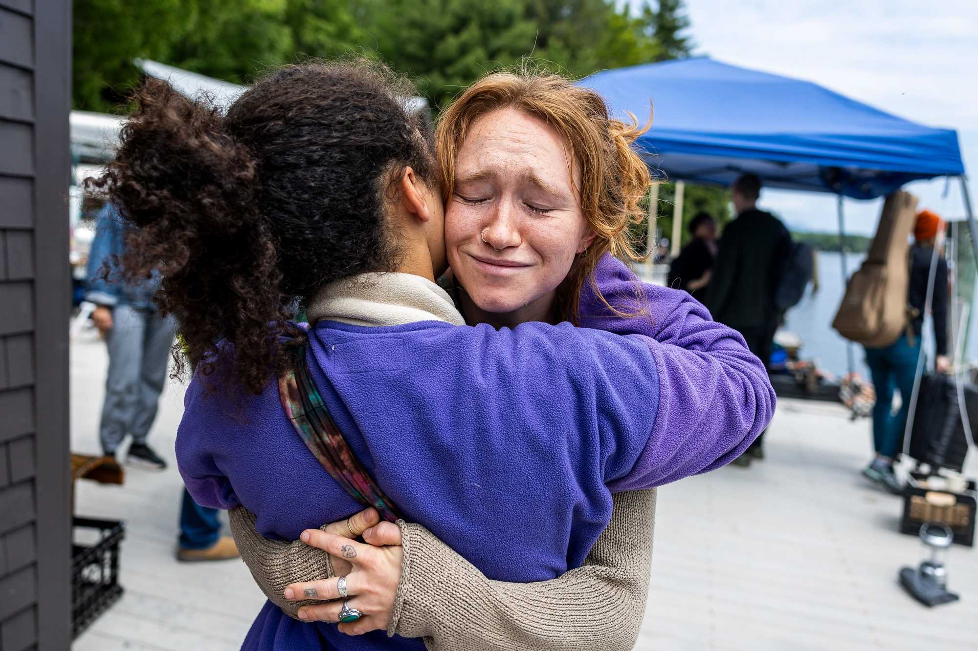 Annie McDougall embraced a friend on the final day of Miles of Music Island Camp before boarding boats back to the mainland from Three Mile Island in New Hampshire.