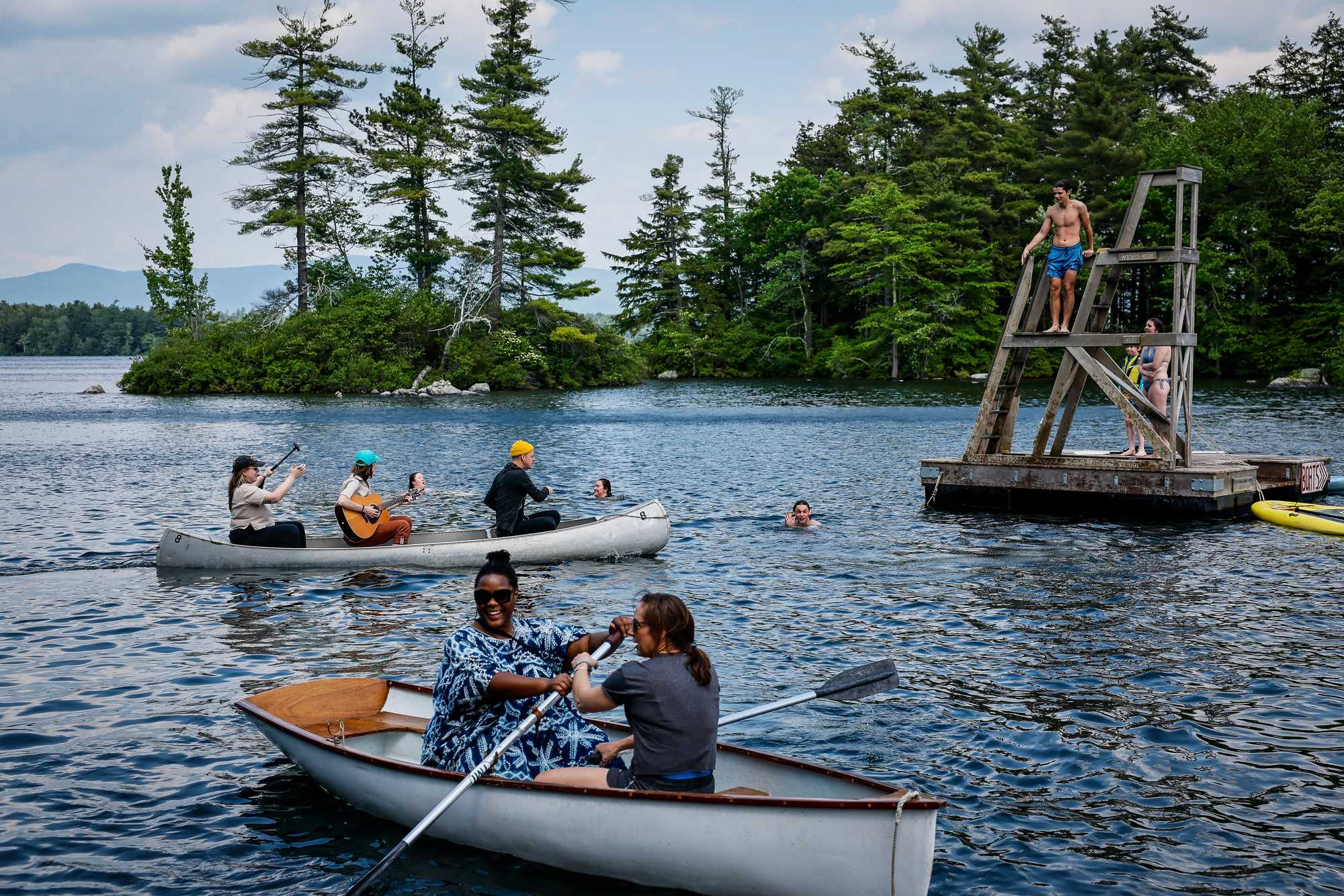 Campers in canoes during an afternoon break at Miles of Music Island Camp on Lake Winnipesaukee.
