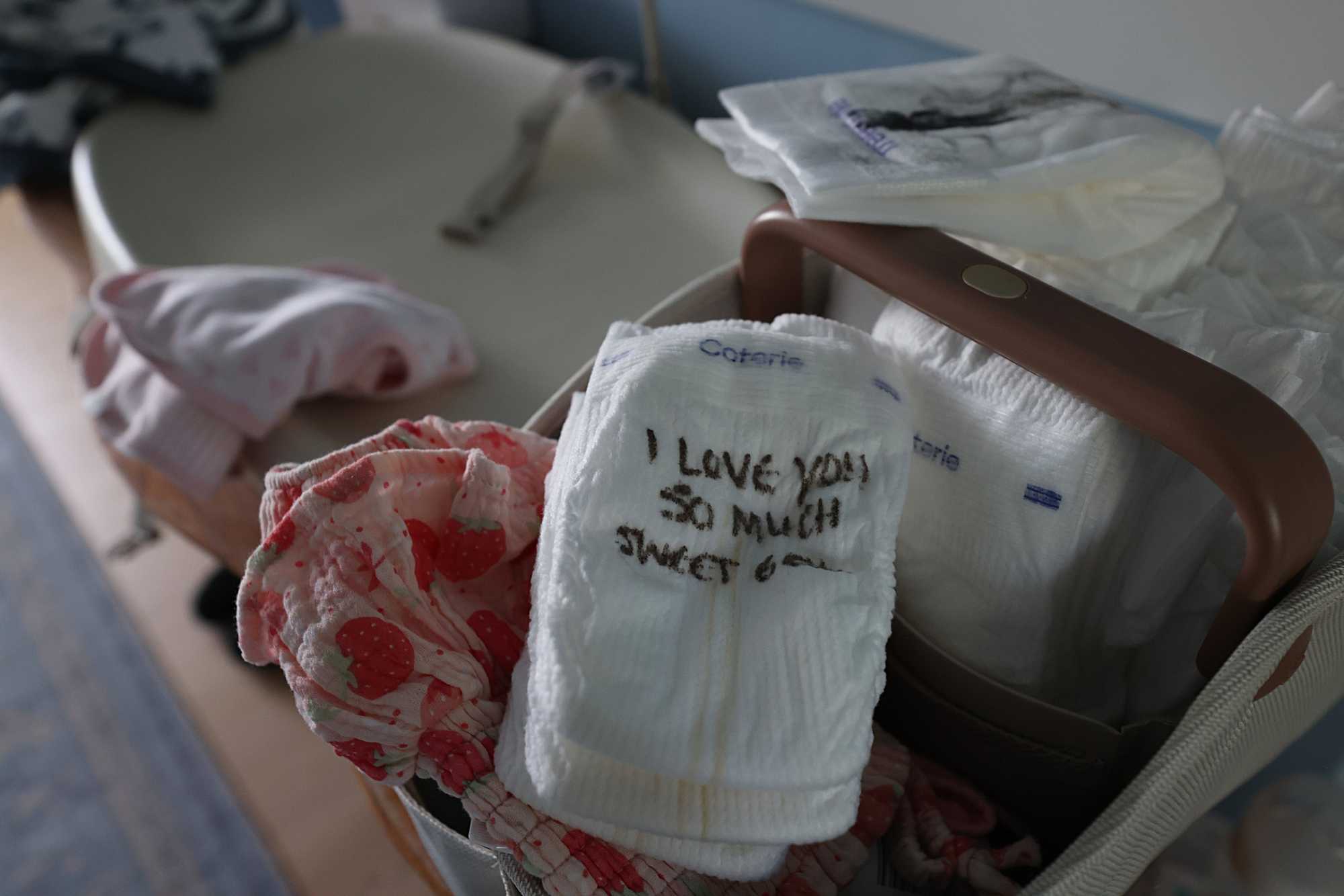 Guests at Adler’s shower signed diapers for her 2-week-old daughter.