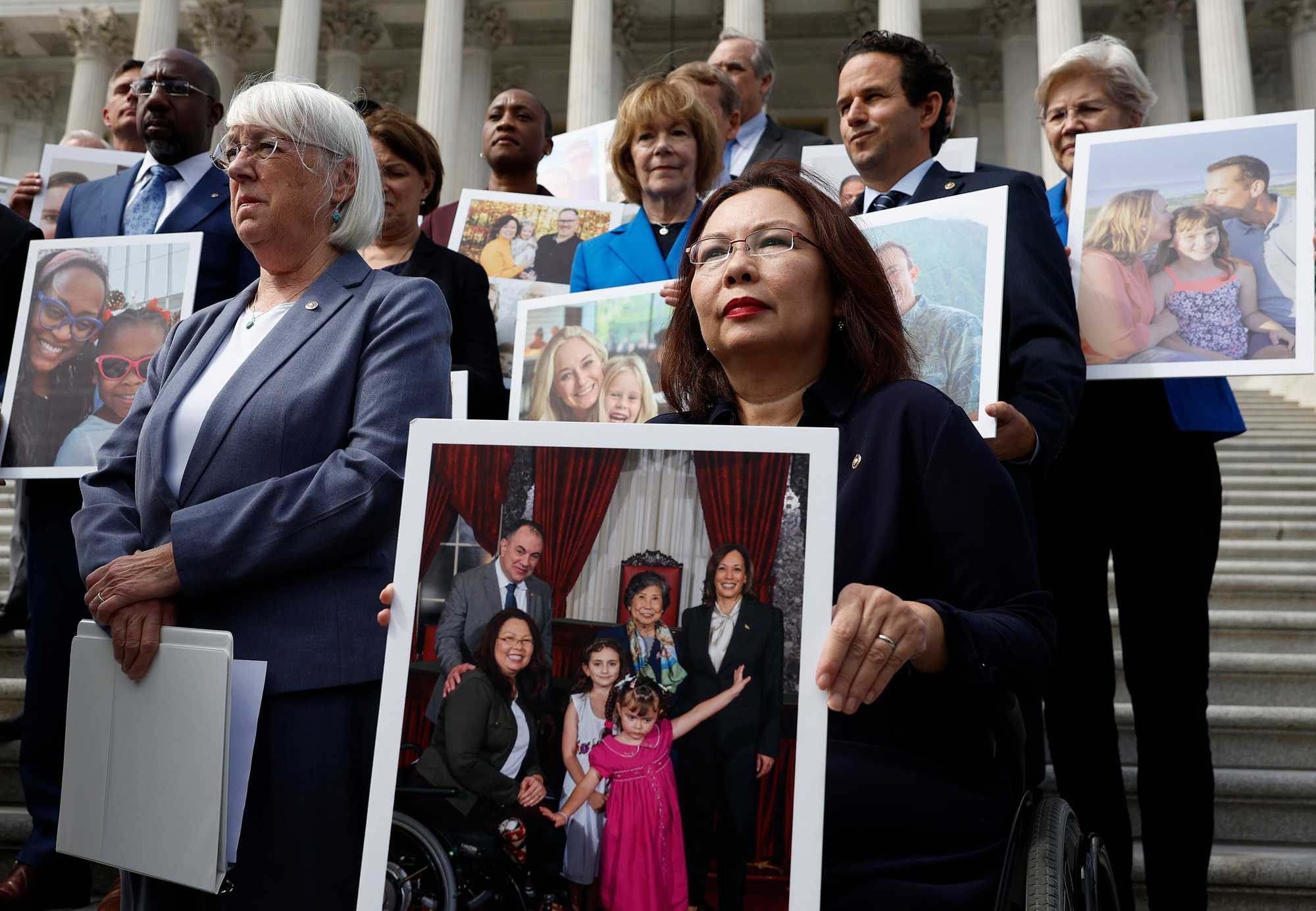 US Senator Tammy Duckworth, an Illinois Democrat and a recipient of IVF treatment, held a photo of her family as she joined fellow Democrats at a press conference outside Capital Hill last year on paying for IVF treatment.