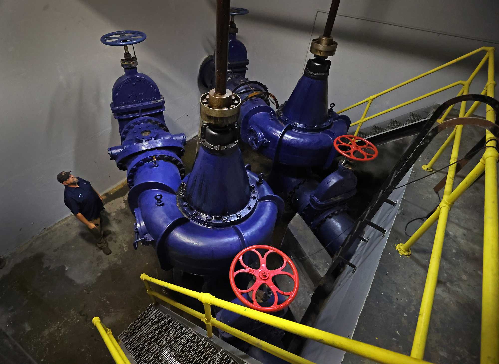 Chris Owsiak, Chicopee's flood control supervisor, looked over pumps installed in 1940 at the  Broadcast Center Flood Control building in Chicopee.