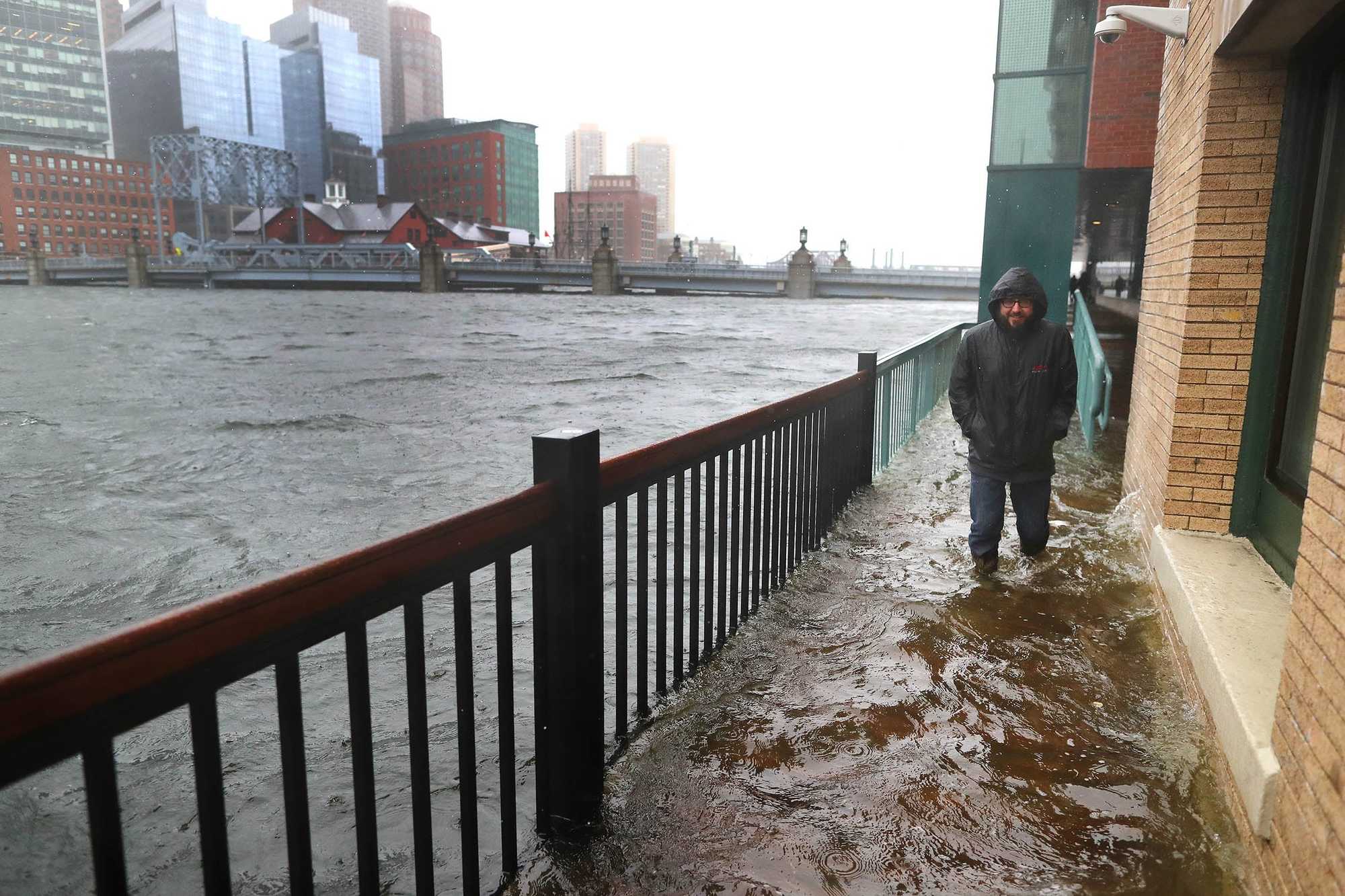A flooded sidewalk off Congress Street along Fort Point Channel, in 2018.