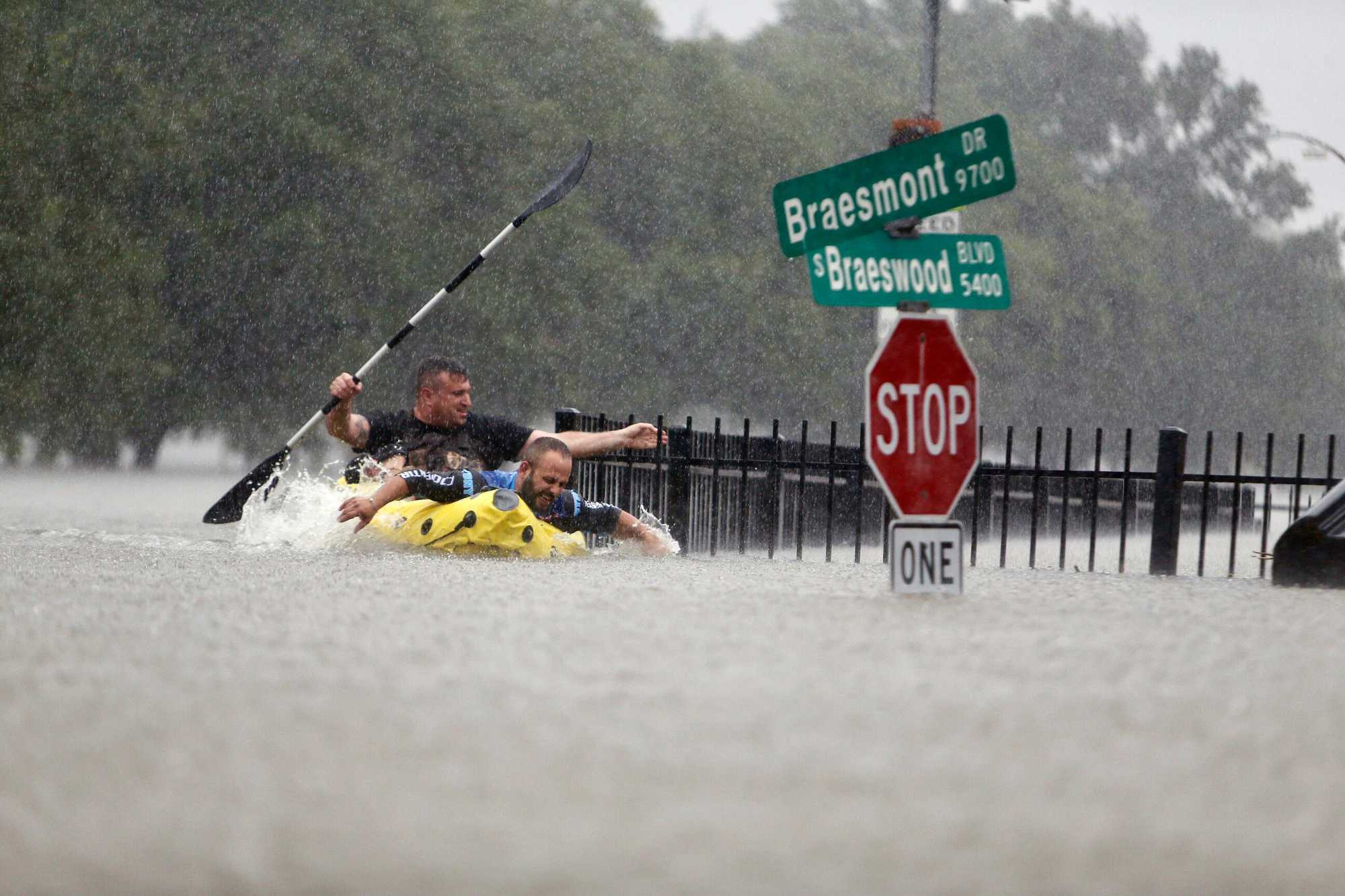 Two kayakers tried to beat the current pushing them down an overflowing Brays Bayou in Houston in August 2017.