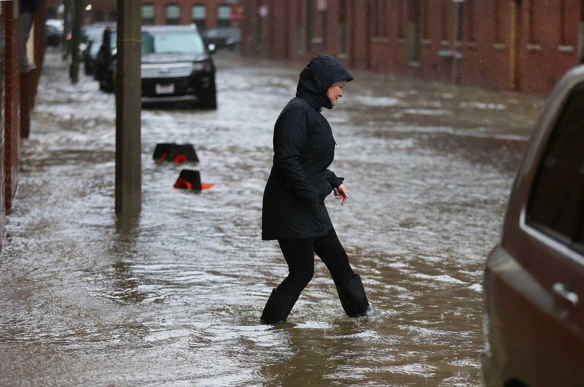A woman checked out the flooding on Sleeper Street in 2018.
(John Tlumacki/Globe Staff)