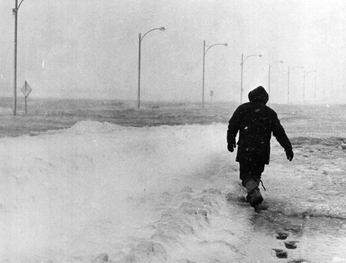 A man walked down a flooded Morrissey Boulevard during the Blizzard of '78. (Janet Knott/Globe Staff)