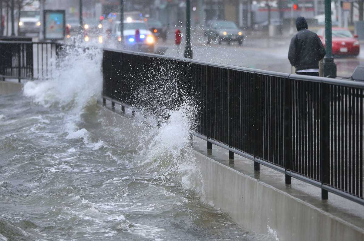 Water washed over Seaport Boulevard. (John Tlumacki/Globe Staff)