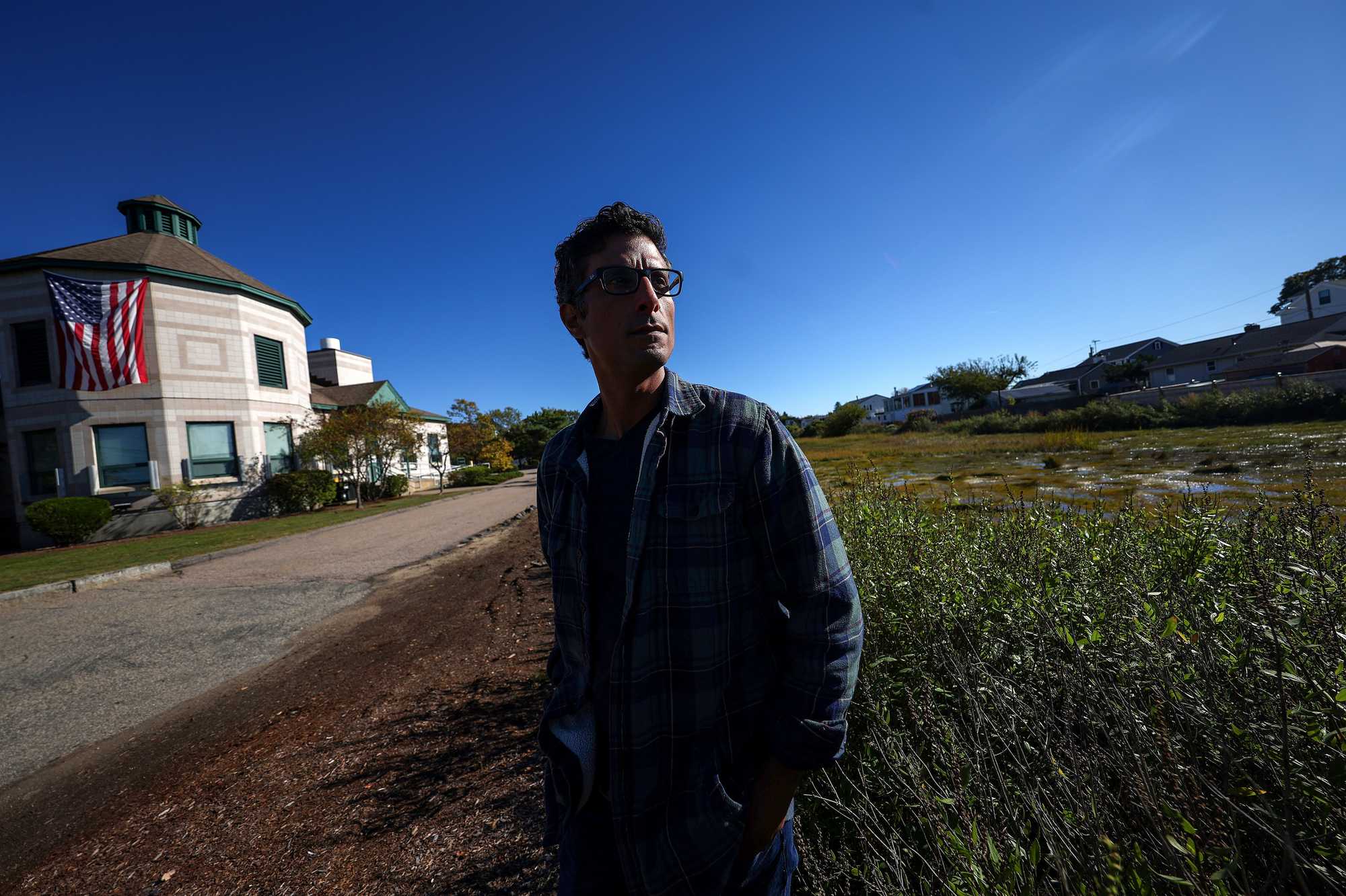 Squantum resident Nasser Brahim near the intersection of East Squantum and Huckins avenues, a pocket of the Quincy neighborhood that floods from overflowing storm drains and a low-lying marsh area.