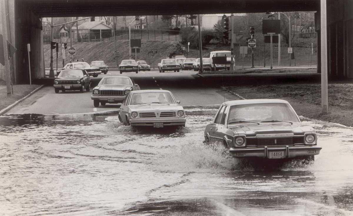 Cars drove through the flooding of Morrissey Boulevard during high tide in January 1979. (George Rizer/Globe Staff)