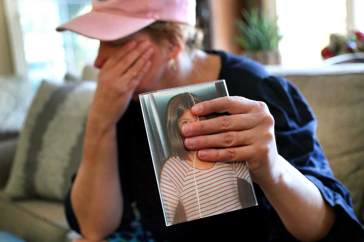 The mother of a girl who fled a Springfield group home to seek shelter in a church holds a favorite photograph of her daughter. The girl, now 18, was mistreated at a group home in Springfield.