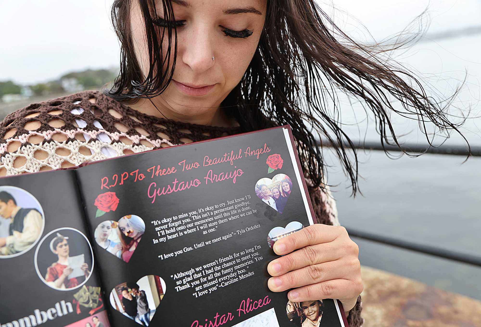 Alexia Thompson held a Gloucester High yearbook open to a page memorializing her friend G Araujo, who died after running away from a group home.