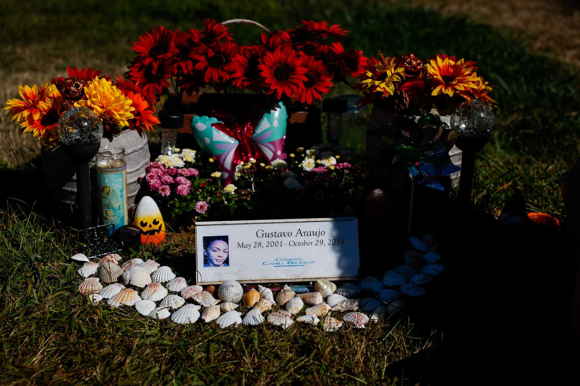 G Araujo’s gravesite in Gloucester is adorned with seashells, flowers, and candles.