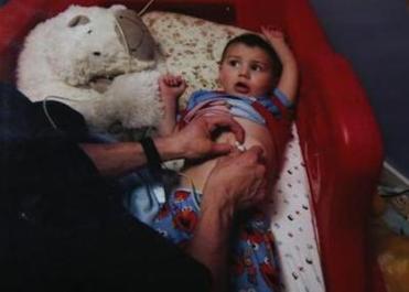 A family photo shows Strider being cared for at home after returning from the hospital with a feeding tube in March 2012.