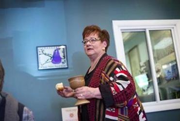 Wendy offered Communion inside the new worship space. Her vision, though, goes beyond these walls. The congregation must look outward to bring people in, she says.