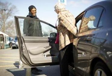 Sanctuary hired a new community minister, the Rev. Lambert N. Rahming Jr., whose focus is on community outreach and building the congregation. Rahming was handing out postcards to invite people to Sanctuary’s Easter sunrise service when he helped this woman to her car.