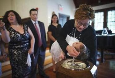 Wendy baptised baby Alexandra Chu in May 2015. It was Sanctuary’s first baptism since selling the church and moving into the storefront. The baptism, though, takes place at North Prospect Union, a traditional church building, where there is more room for the celebration. But the family only returns to Sanctuary a few times after the baptism.