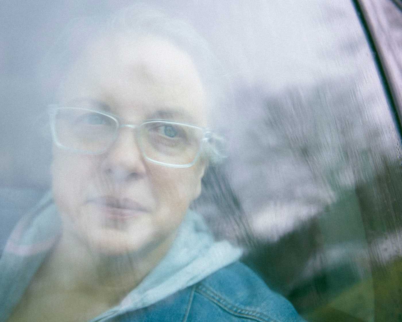 Kate looks out of her car window while visiting her childhood hometown.