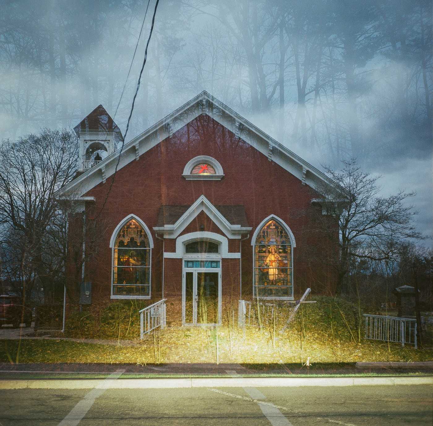 A double-exposure of the church Kate attended as a child overlaid with the woods at the rest area.
