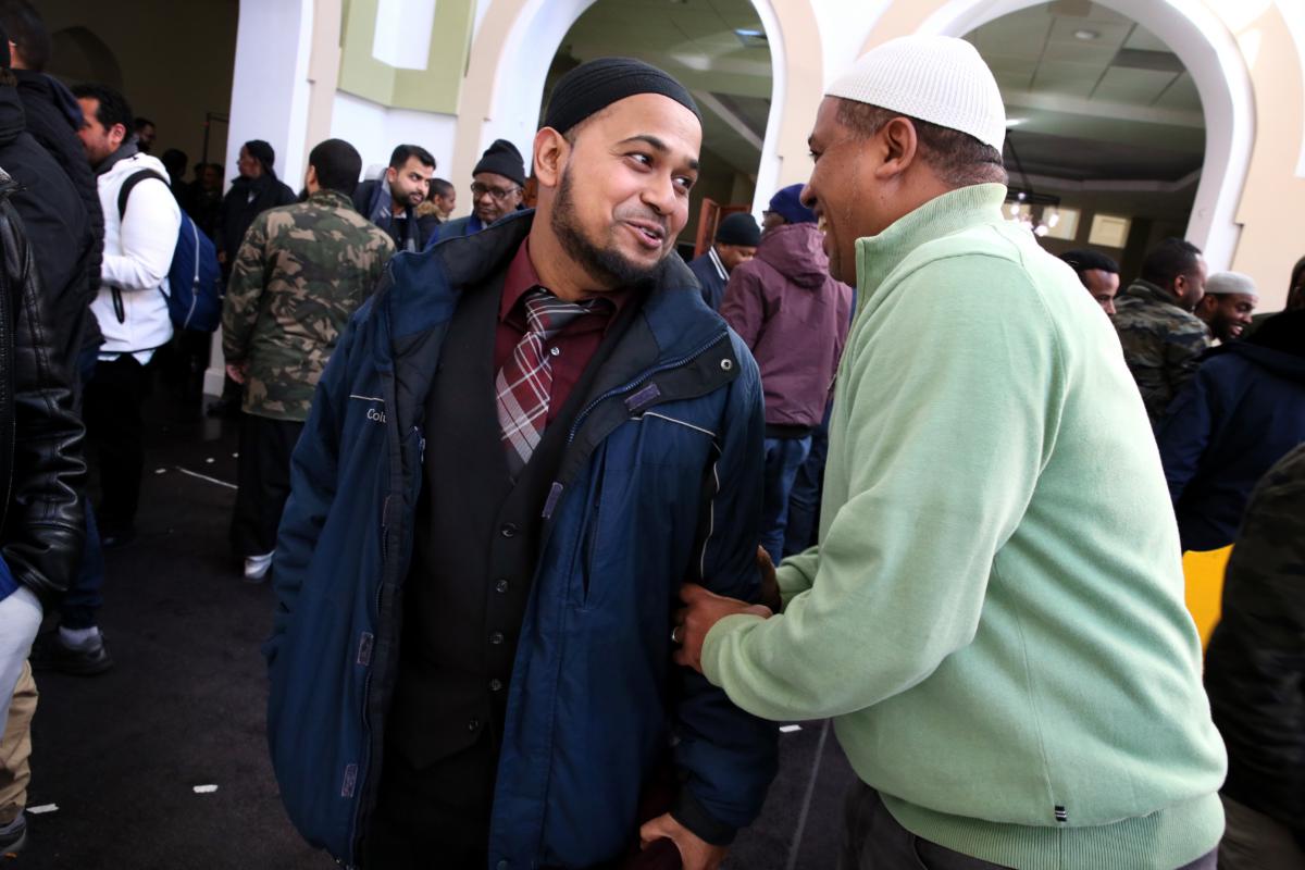 Abadur Rahman, the 2006 valedictorian at East Boston High School, talks with Mohamed Nour following the Friday prayer at the Islamic Society of Boston Cultural Center.