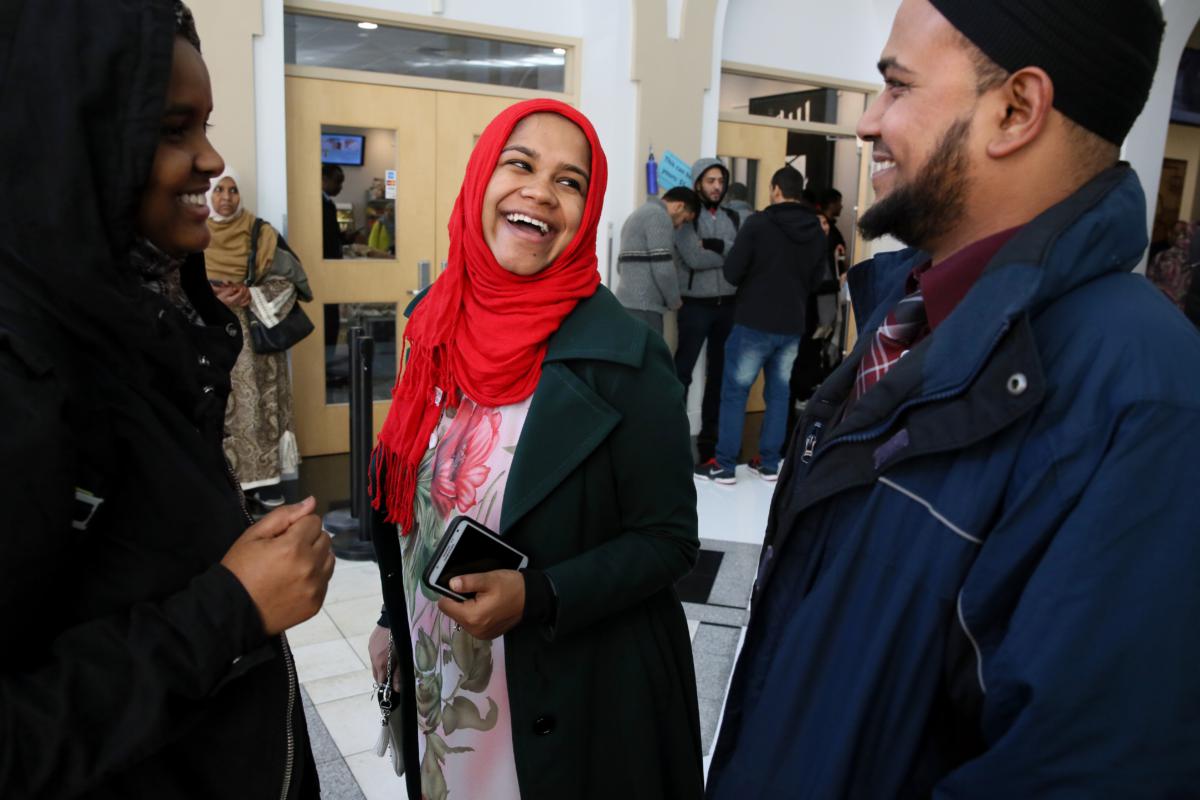 Rahman shared a laugh with his wife, Rehena Rana (center), and a friend following the Friday prayer at the Islamic Society of Boston Cultural Center.