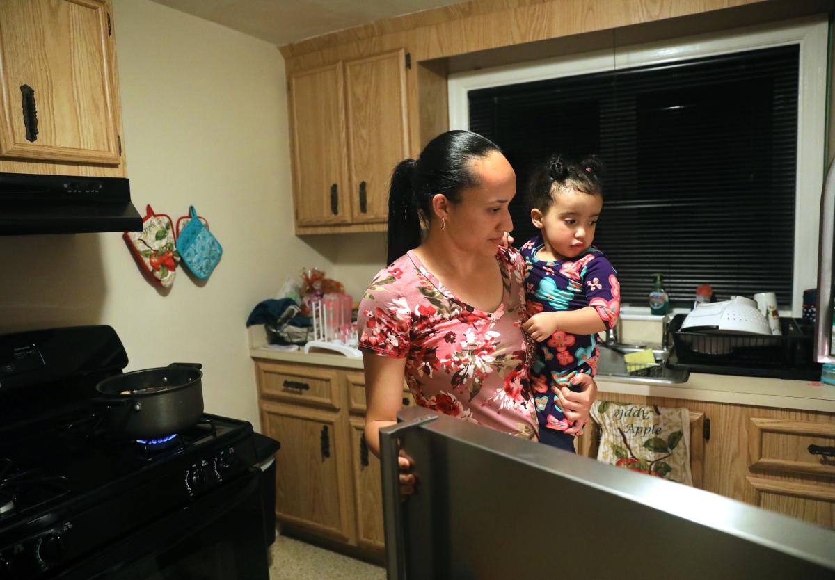 Ruiz at home with her 2-year-old daughter, Yaneisy Gonzalez Ruiz, in October. She cooked mangu' de guineitos (mashed green bananas) for her fiance before he went to work.