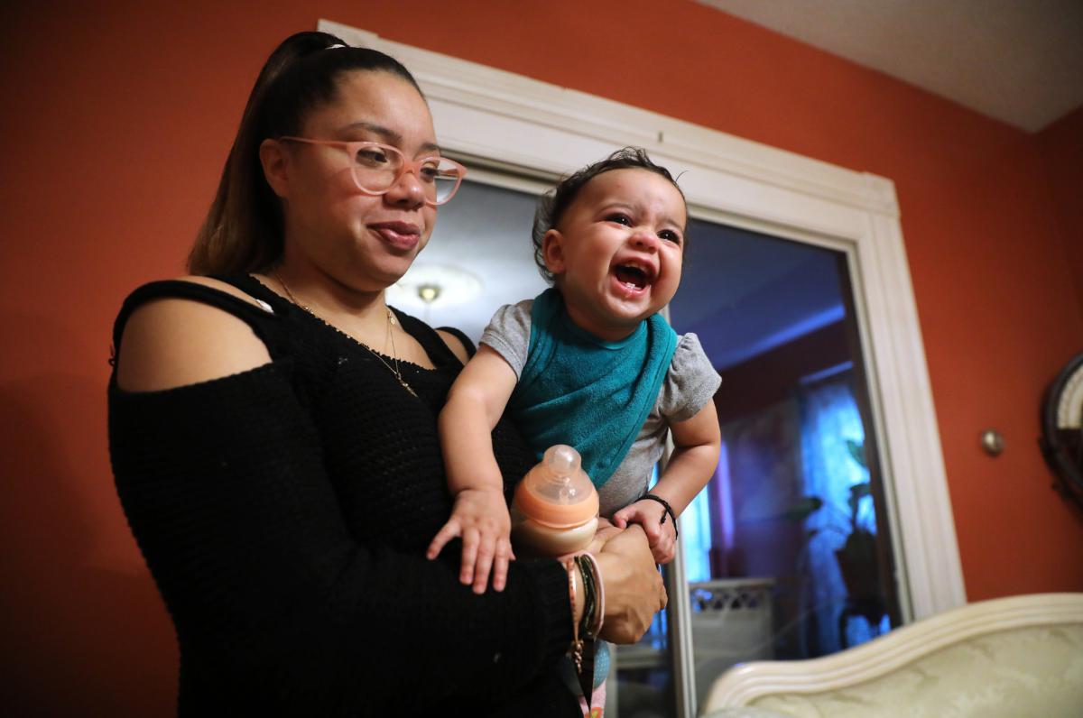 Telma Tavares, held her 8-month-old daughter, Grey Tavares, in her Dorchester home last October. She wants to open an acupuncture business one day.