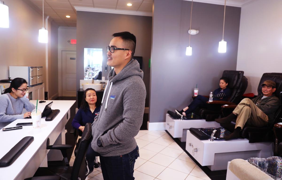 Trinh hanging out at his sister’s business, Modern Nails Spa in Beverly,  in October. His sister, Phuong Trinh (left), was the 2007 valedictorian at Academy of Public Service. Also shown are his mother, Tuyet Nguyen; his wife, Thanh Huynh (center); and his father, Tam Trinh.