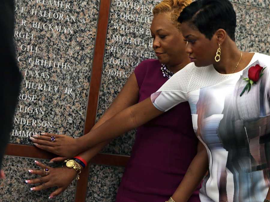  Roxanne Simmonds (left) mother of BPD Office Dennis O. Simmonds and Nicole Simmonds, sister, touched the engraved wall during today's memorial service dedicated to Boston Police officer Dennis Simmonds who died from head injuries.