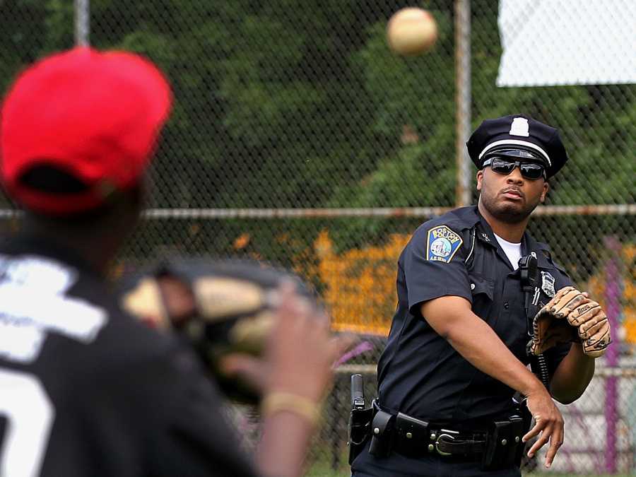  Boston Police Officer Dennis Simmonds tossed the ball with little league pitcher in 2011.