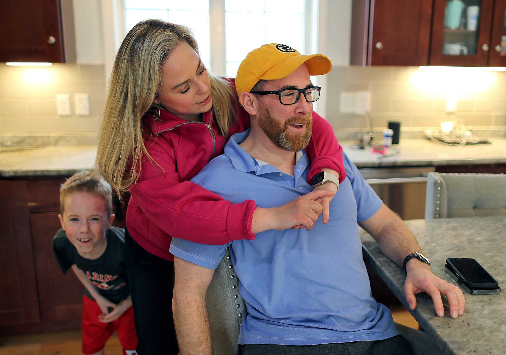 Dic Donohue was hugged by wife Kim in the kitchen of their home as their 6-year-old son, Connor, looked on.
