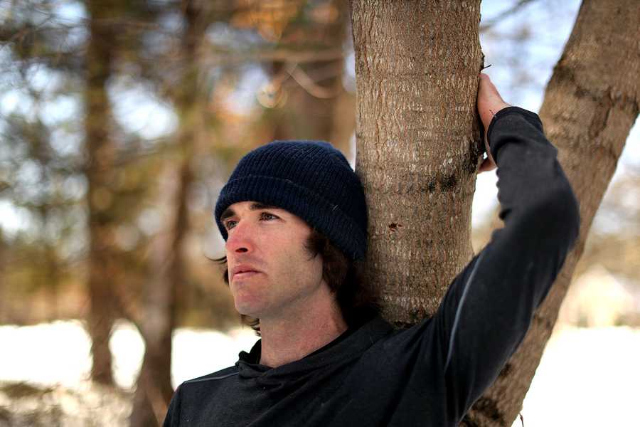  Bobby O’Donnell  unwinds against a tree on a trail he runs along near his Hopkinton home. He was a 19-year-old runner in the 2013 Boston Marathon and was on Mass. Ave when he heard the bombs go off. 