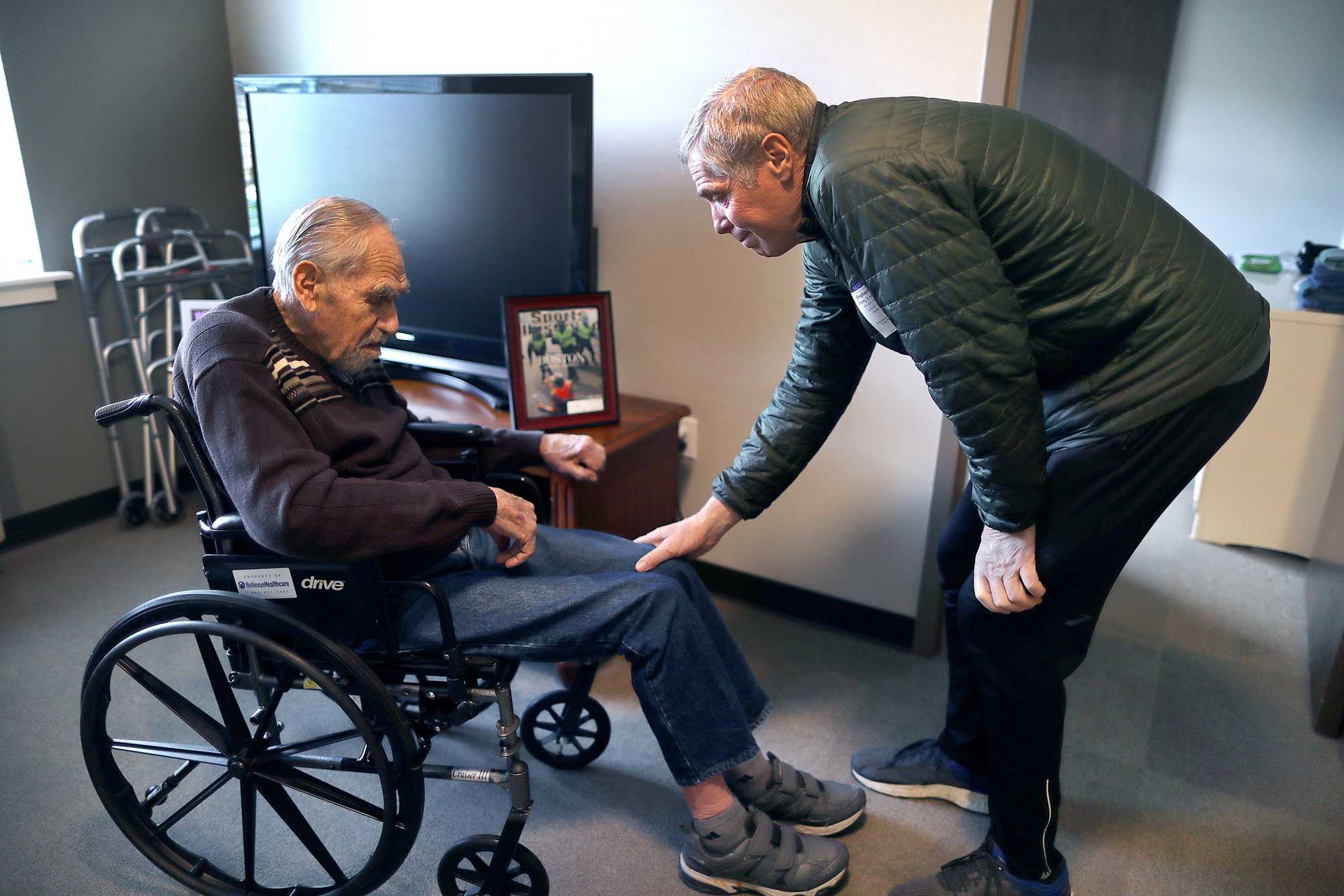 Mark Iffrig tried to wake up his dad, Bill Iffrig, 88, who was napping in his wheelchair in his room at Fieldstone Memory Care Since in Marysville, Wash.