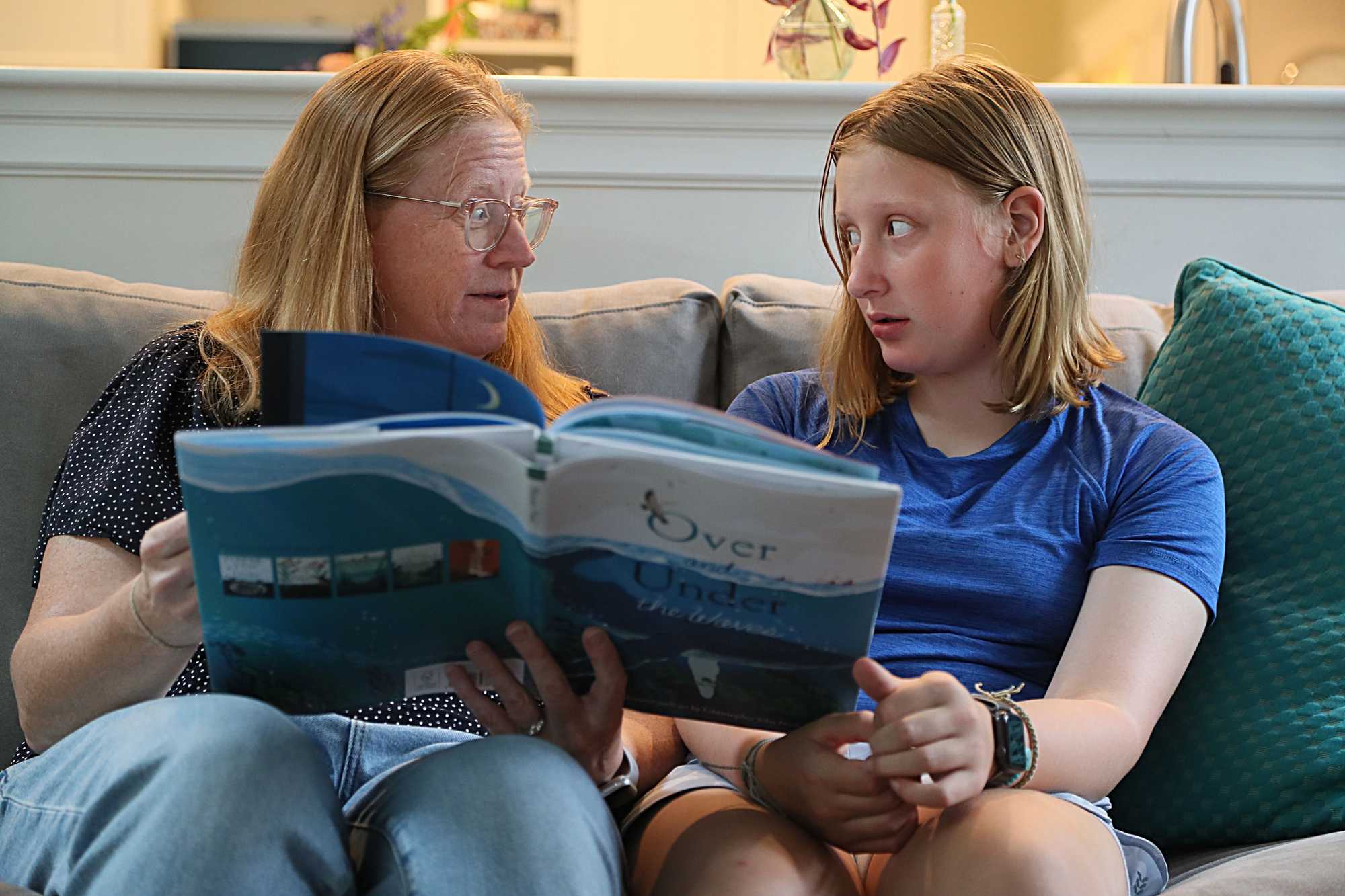 Ali Lynch read with her daughter Claire, 11, at their home in Lexington.