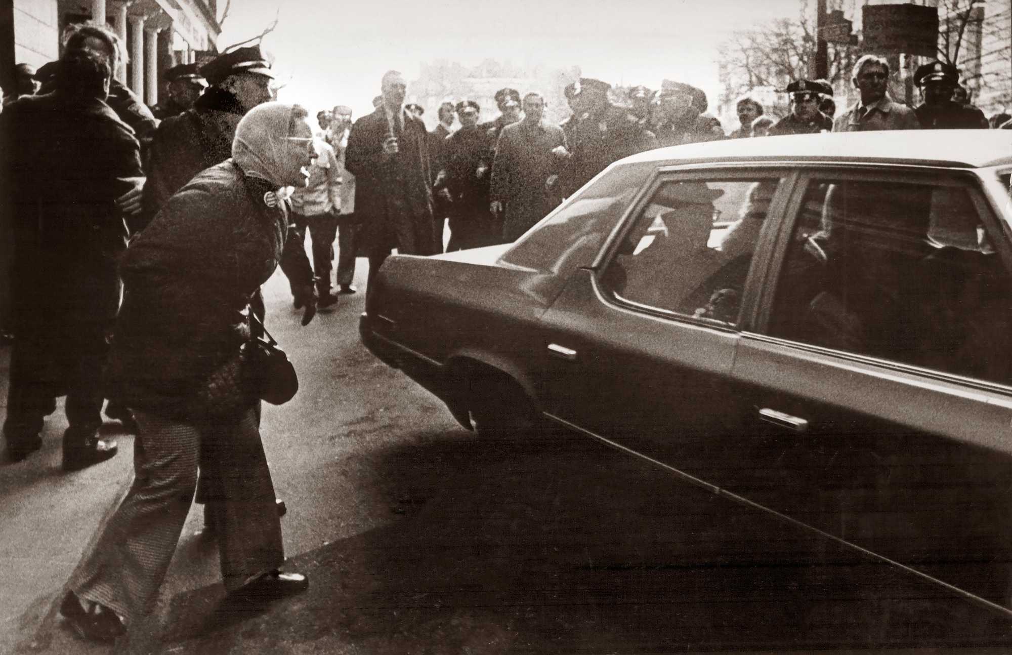 Making her position clear, a woman yelled at the car carrying Judge W. Arthur Garrity Jr. on Boston’s Beacon Street in March 1975.