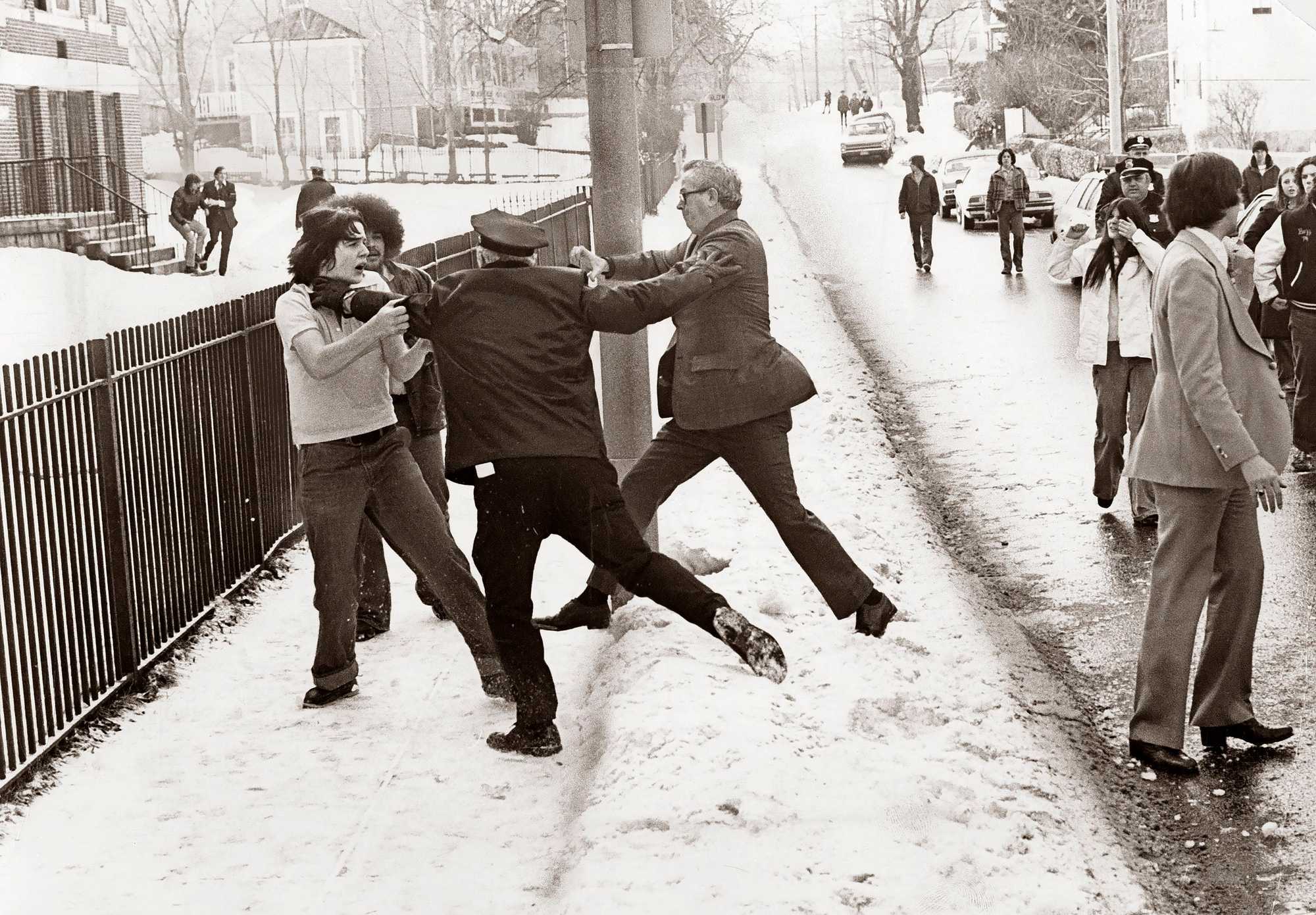 Police moved in to disperse students outside Hyde Park High School on Jan. 21, 1976, after a midmorning melee involving hundreds of students, the most serious racial confrontation there since Boston's Phase 2 desegregation began the year before.  (Paul Connell/Globe Staff) 